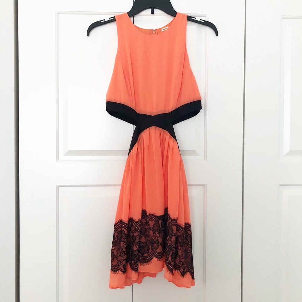 Coral dress with side cutouts and lace